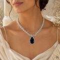 Model wearing sapphire teardrop leaf necklace by Bright & Beryl