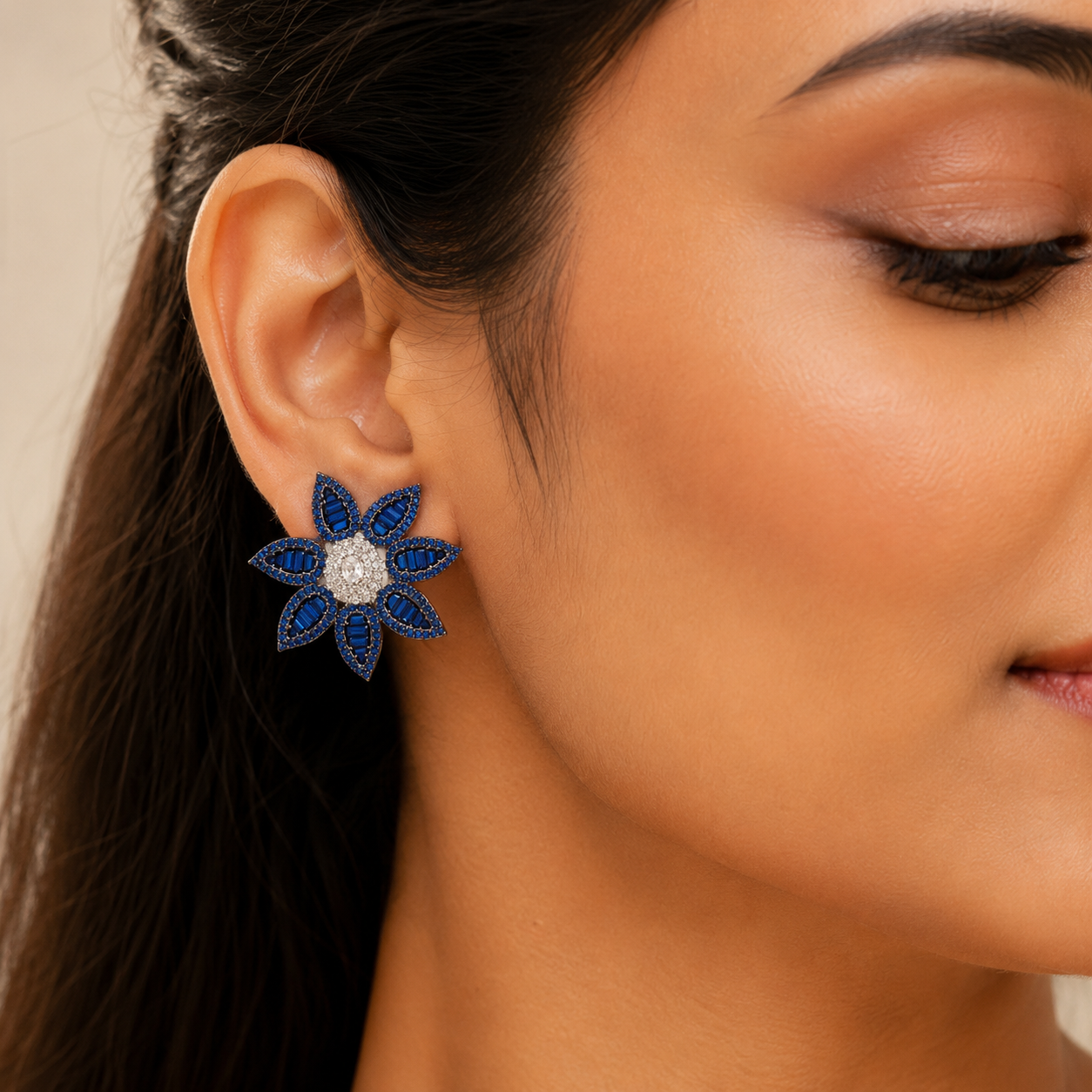 Blue floral statement earrings worn by an Indian model
